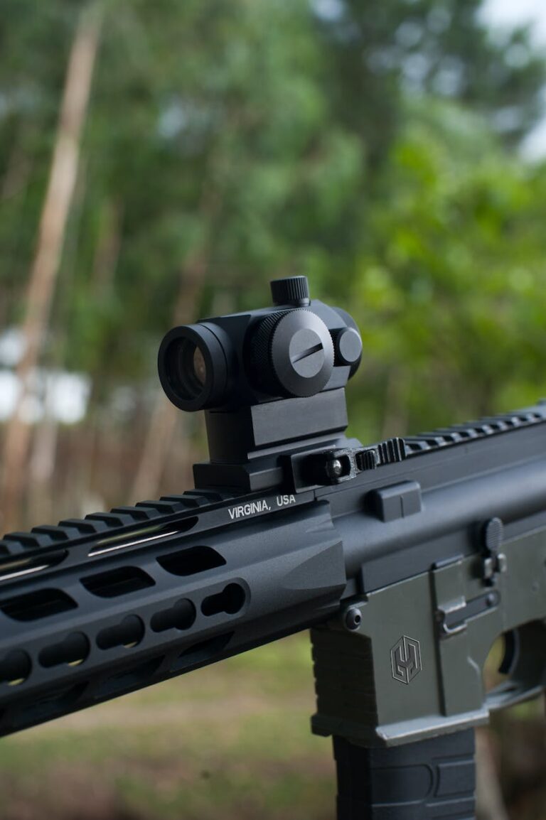 close up shot of black rifle with scope