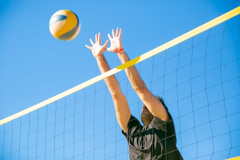 man blocking a ball over the net