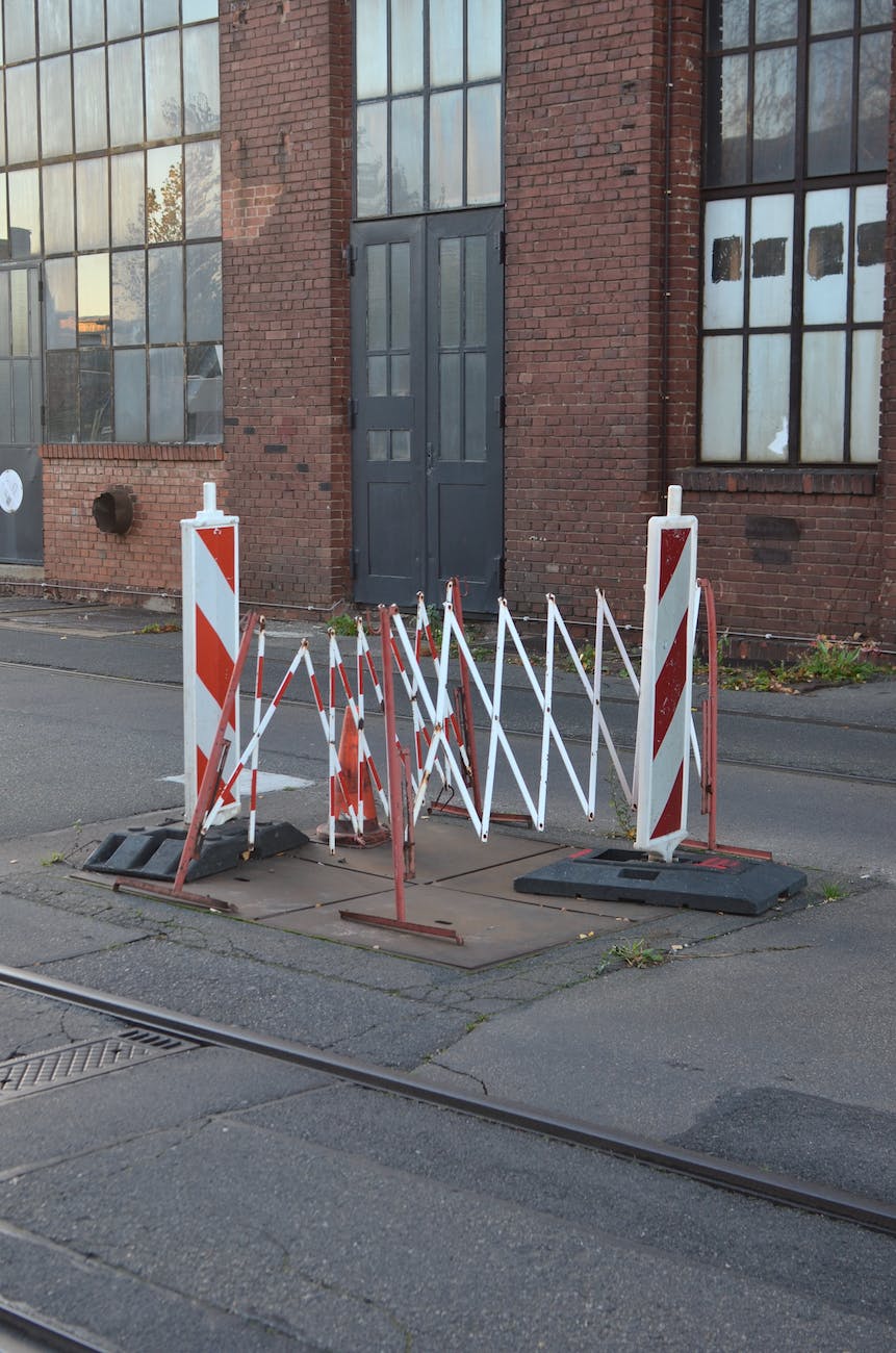 railings around hatch on asphalt carriageway