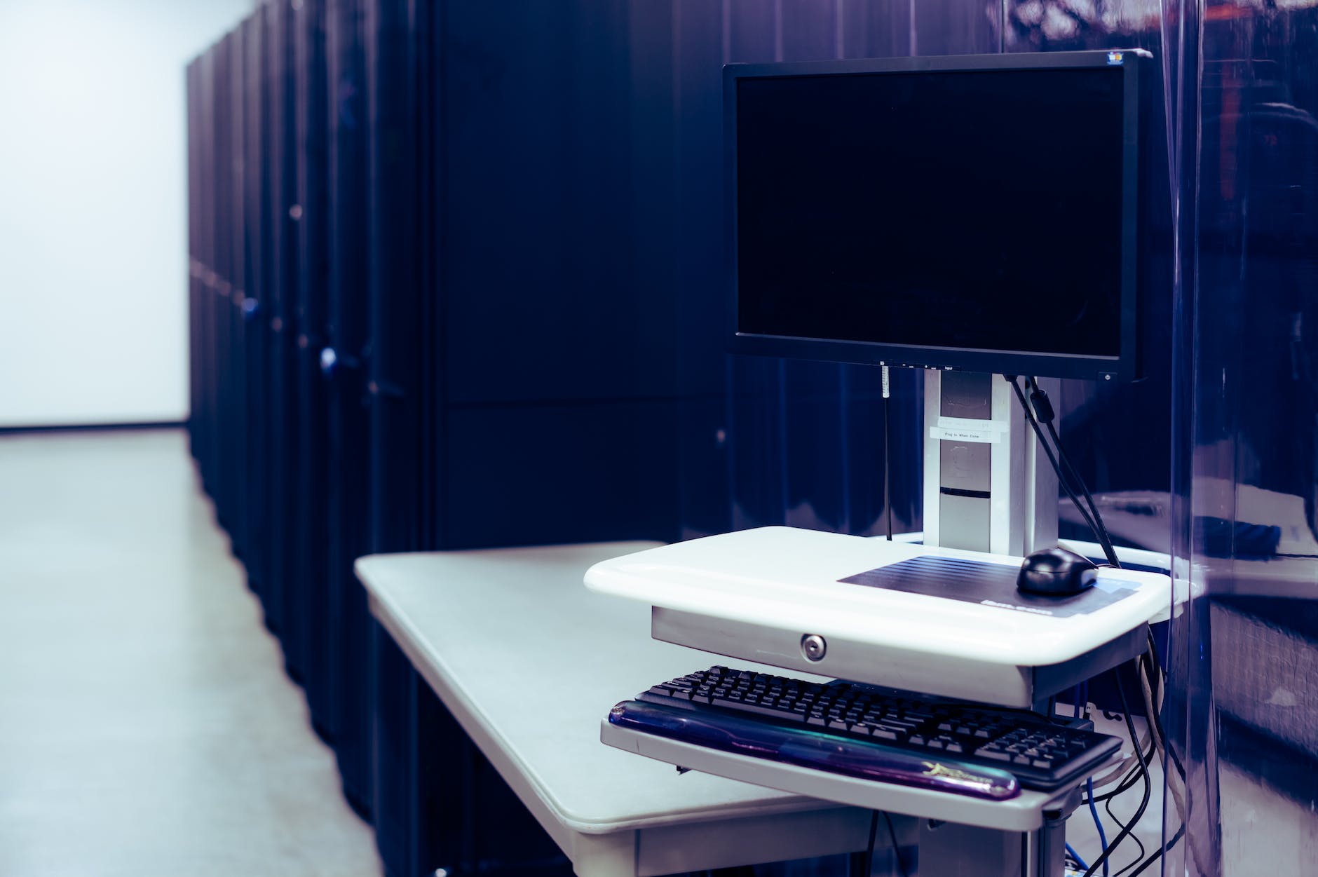 modern computer placed near server racks