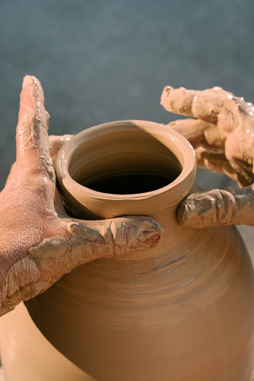 person making clay pot