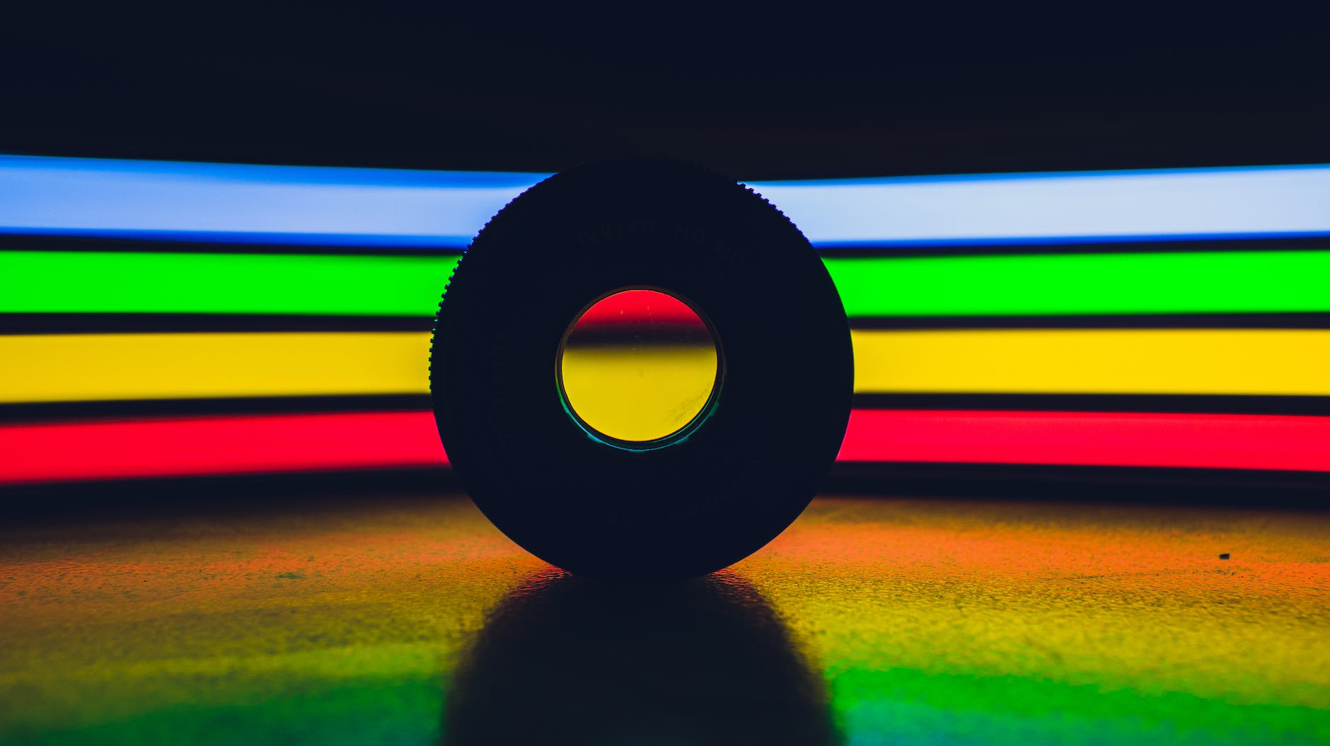 disk against colorful spectrum lights